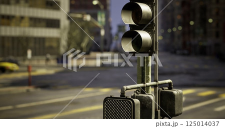 Traffic lights at a quiet intersection in an urban setting during dawn 125014037