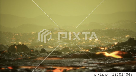 Volcanic landscape with flowing lava and hazy atmosphere at dusk 125014045