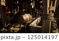 An old wooden barrel and water trough in a rustic workshop during daylight 125014197