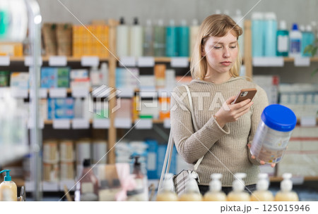Young woman scanning qr code of baby formula 125015946