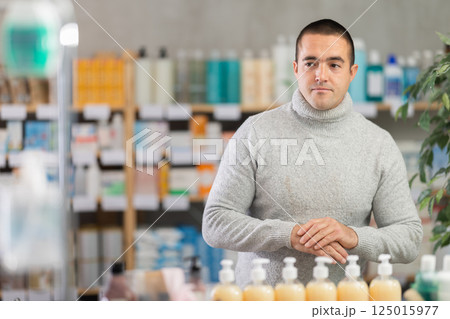 Young man choosing medicines and hygiene products Young man choosing medicines and hygiene products 125015977