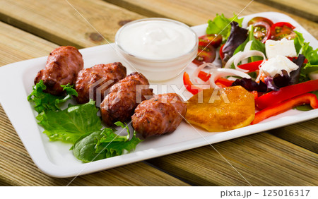 Minced meat kebapcheta served with salad of greens and brynza Minced meat kebapcheta served with salad of greens and brynza 125016317