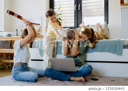 Father with three daughters trying to work from homeoffice. Father with three daughters trying to work from homeoffice. 125016441