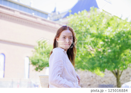 庭でリラックスする若い女性 125016884