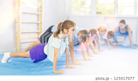 Children are performing push-ups 125017077