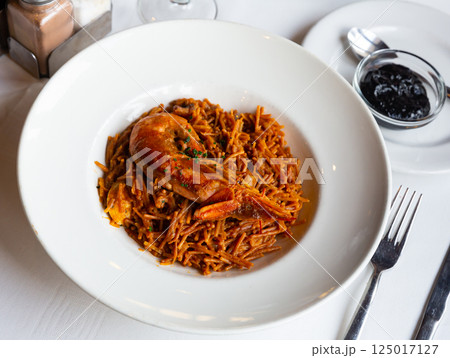 Seafood fideua with mussels, prawns and black allioli Seafood fideua with mussels, prawns and black allioli 125017127