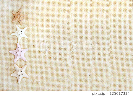 Vacations background with four starfishes on canvas texture. Topic of vacation, travel, trip abroad on vacation, cruises and tours. Mock up template. Copy space for text 125017334