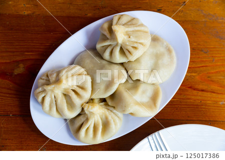 Traditional Georgian Khinkali dumplings stuffed with meat Traditional Georgian Khinkali dumplings stuffed with meat 125017386