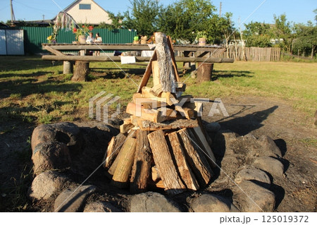 wooden logs are stacked to light a fire 125019372