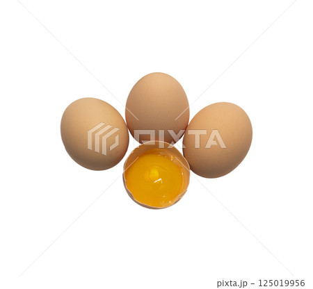 Light brown organic raw chicken eggs with yolk in package isolated on white background. Light brown organic raw chicken eggs with yolk in package isolated on white background. 125019956