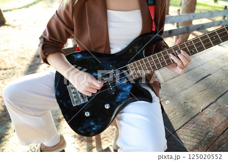 Hands Girl Plays The Bass Musical Instrument Among The Trees In The Park 125020552