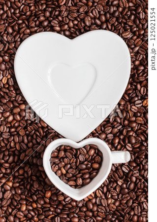 cup and saucer on coffee beans background cup and saucer on coffee beans background 125021554
