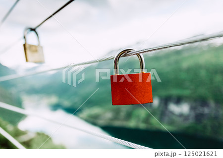Red padlock and Geirangerfjord from Flydasjuvet viewpoint Norway Red padlock and Geirangerfjord from Flydasjuvet viewpoint Norway 125021621