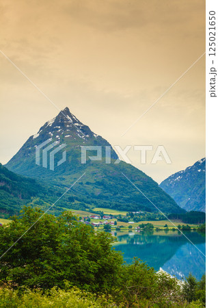 Reflection of mountains in norwegian fjord lake Reflection of mountains in norwegian fjord lake 125021650
