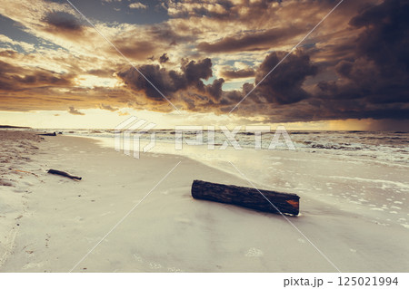 Beatiful sunset with clouds over sea and beach 125021994