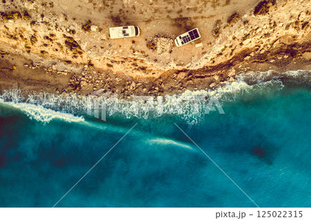 Two caravans solar panels on roof camp on seashore. Aerial view 125022315