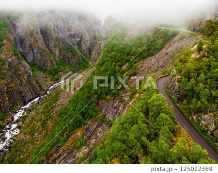 Road and stream in green mountains, Norway 125022369