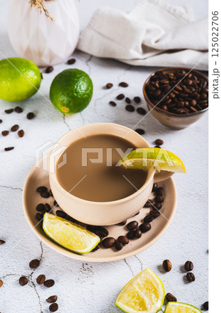 A cup of latte infused with lime on the table vertical view 125022706