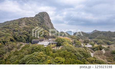 March 26 2025 Peaceful Hillside with Dense Green Forest and Architectural Building 125023198