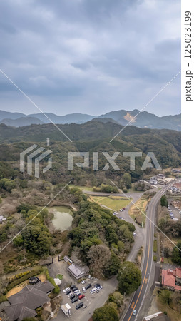 March 26 2025 Scenic Rural Landscape with Dense Forest and Winding Roads 125023199