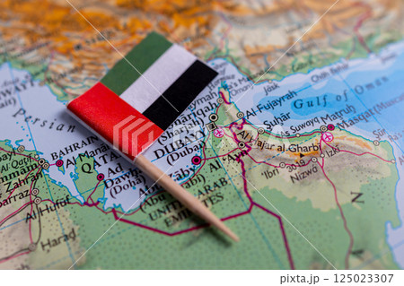 Flag of the United Arab Emirates (UAE) close-up on the map. The capital Abu Dhabi. A close-up of the world map. UAE 125023307