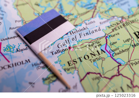 Flag of Estonia close-up on the map. Capital Tallinn. Close-up of the world map. Estonia Flag of Estonia close-up on the map. Capital Tallinn. Close-up of the world map. Estonia 125023316