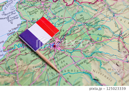 Flag of France close-up on the map near the capital Paris. A close-up of the world map. France Flag of France close-up on the map near the capital Paris. A close-up of the world map. France 125023339
