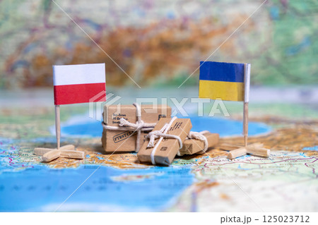 Flag of Poland and Ukraine on the world map next to delivered parcels. Economy, aid, trade Flag of Poland and Ukraine on the world map next to delivered parcels. Economy, aid, trade 125023712
