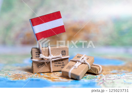 Flag of Austria near the parcels on the world map. World trade. Exports and imports of goods. Economy of the country. Flag of Austria near the parcels on the world map. World trade. Exports and imports of goods. Economy of the country. 125023731