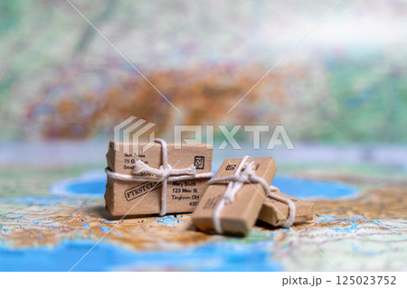 Small parcels lie on the world map. World trade, export and import of goods around the world 125023752