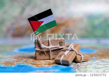 Flag of Palestine near the parcels on the world map. World trade. Exports and imports of goods. Economy of the country Flag of Palestine near the parcels on the world map. World trade. Exports and imports of goods. Economy of the country 125023772