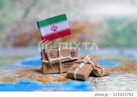Flag of Iran near the parcels on the world map. World trade. Exports and imports of goods. Economy of the country 125023782