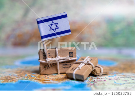 Flag of Israel near the parcels on the world map. World trade. Exports and imports of goods. Economy of the country Flag of Israel near the parcels on the world map. World trade. Exports and imports of goods. Economy of the country 125023783