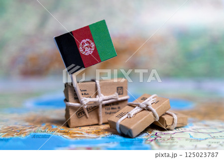 Flag of Afghanistan near the parcels on the world map. World trade. Exports and imports of goods. Economy of the country 125023787