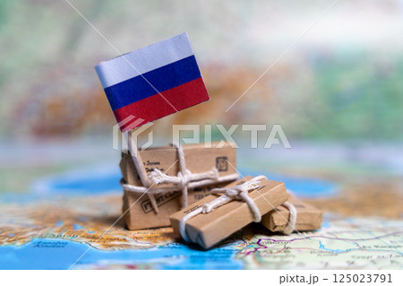 Flag of Russia near the parcels on the world map. World trade. Exports and imports of goods. Economy of the country. 125023791