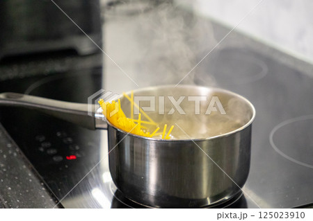 Cooking Spaghetti Pasta on a Stove. Cooking food in the kitchen 125023910