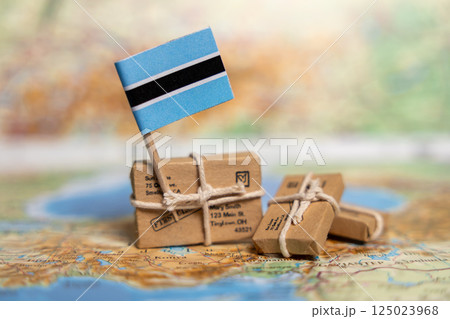 International Shipping and Delivery Services: Small Packages with Botswana Flag on World Map Illustrating Global Postal System International Shipping and Delivery Services: Small Packages with Botswana Flag on World Map Illustrating Global Postal System 125023968