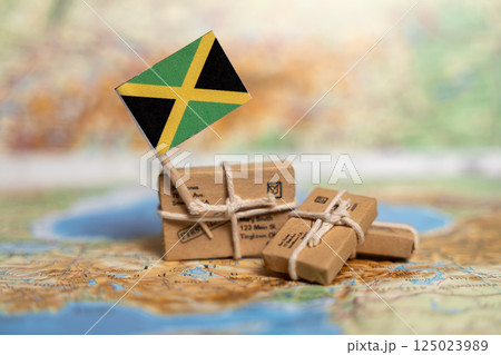 Shipping and Delivery Services to Jamaica: International Mail Packages with Jamaican Flag on World Map Background Shipping and Delivery Services to Jamaica: International Mail Packages with Jamaican Flag on World Map Background 125023989