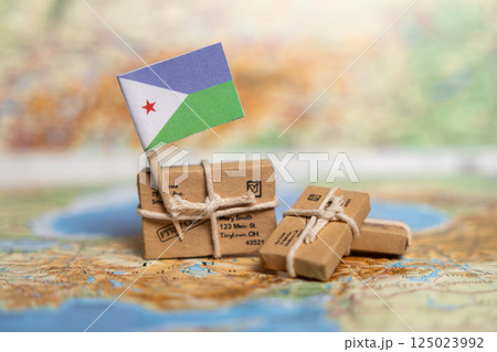 Small Packages with Djibouti Flag on World Map Show International Shipping and Mail Delivery Services Worldwide 125023992