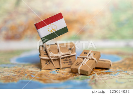 Global Shipping and Trade: Tajikistan Flag with Parcels on World Map Highlighting Central Asian Commerce and Delivery Services Global Shipping and Trade: Tajikistan Flag with Parcels on World Map Highlighting Central Asian Commerce and Delivery Services 125024022