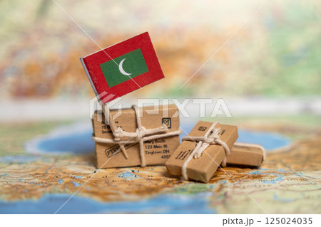 nternational Shipping to Maldives: Small Packages with Maldivian Flag on Global Map, Worldwide Postal Delivery Services Concept nternational Shipping to Maldives: Small Packages with Maldivian Flag on Global Map, Worldwide Postal Delivery Services Concept 125024035