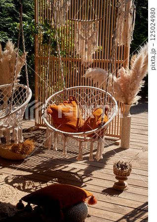 Wedding decoration. Floristics. Outdoor swing with pillows. A place for guests to relax 125024980