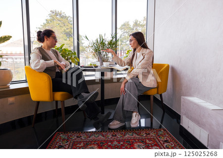 Business content development over coffee. Concept of team alignment and remote leadership. Wide shot Business content development over coffee. Concept of team alignment and remote leadership. Wide shot 125025268