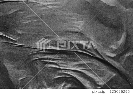 Black crumpled and creased paper poster grunge texture background Black crumpled and creased paper poster grunge texture background 125026296