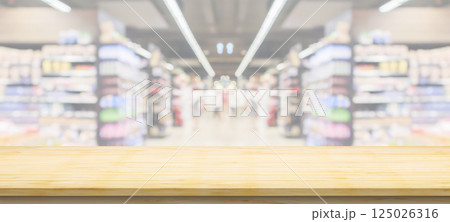 Empty wood table top with supermarket grocery store aisle and shelves blurred background 125026316