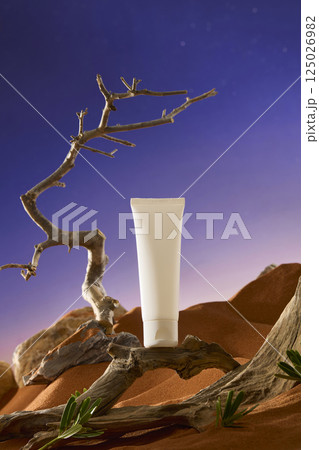 Winding branches with many cracks on the trunk, concave and convex places randomly, form a pedestal for the unlabeled tube of cream. The dry, thorny branches point straight up to the sky.  125026982