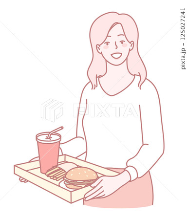 A Young Woman is Happily Enjoying a Fast Food Meal Along with a Refreshing Drink A Young Woman is Happily Enjoying a Fast Food Meal Along with a Refreshing Drink 125027241