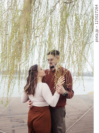Romance outdoors dancing. Happy young couple dancing in stylish clothes. Romantic and spontaneous date moment Romance outdoors dancing. Happy young couple dancing in stylish clothes. Romantic and spontaneous date moment 125027264
