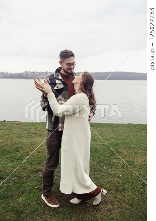 Romance outdoors dancing. Happy young couple dancing in stylish clothes. Romantic and spontaneous date moment Romance outdoors dancing. Happy young couple dancing in stylish clothes. Romantic and spontaneous date moment 125027283