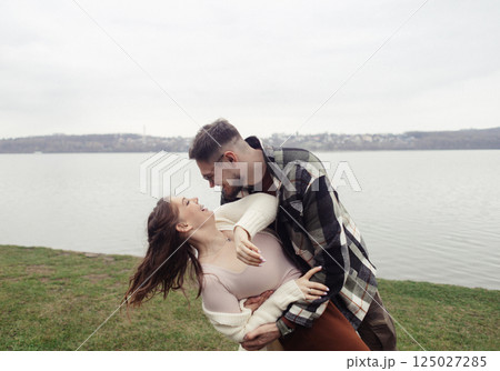 Romance outdoors dancing. Happy young couple dancing in stylish clothes. Romantic and spontaneous date moment Romance outdoors dancing. Happy young couple dancing in stylish clothes. Romantic and spontaneous date moment 125027285